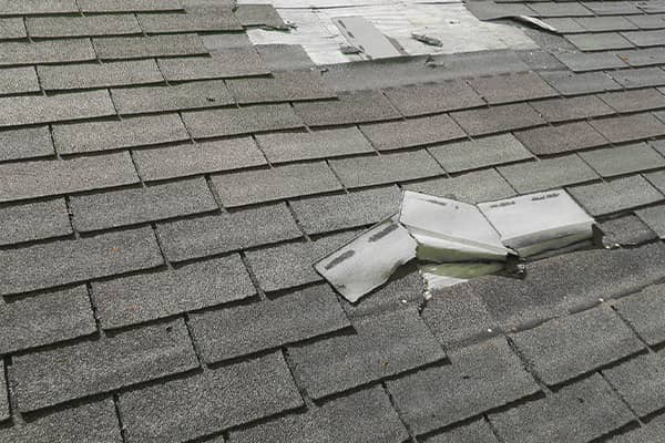 Close-up of worn asphalt shingles being prepared for a reroofing project in Gainesville, TX