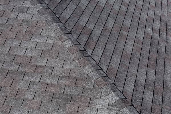 Detail of newly repaired architectural asphalt shingles on a residential roof